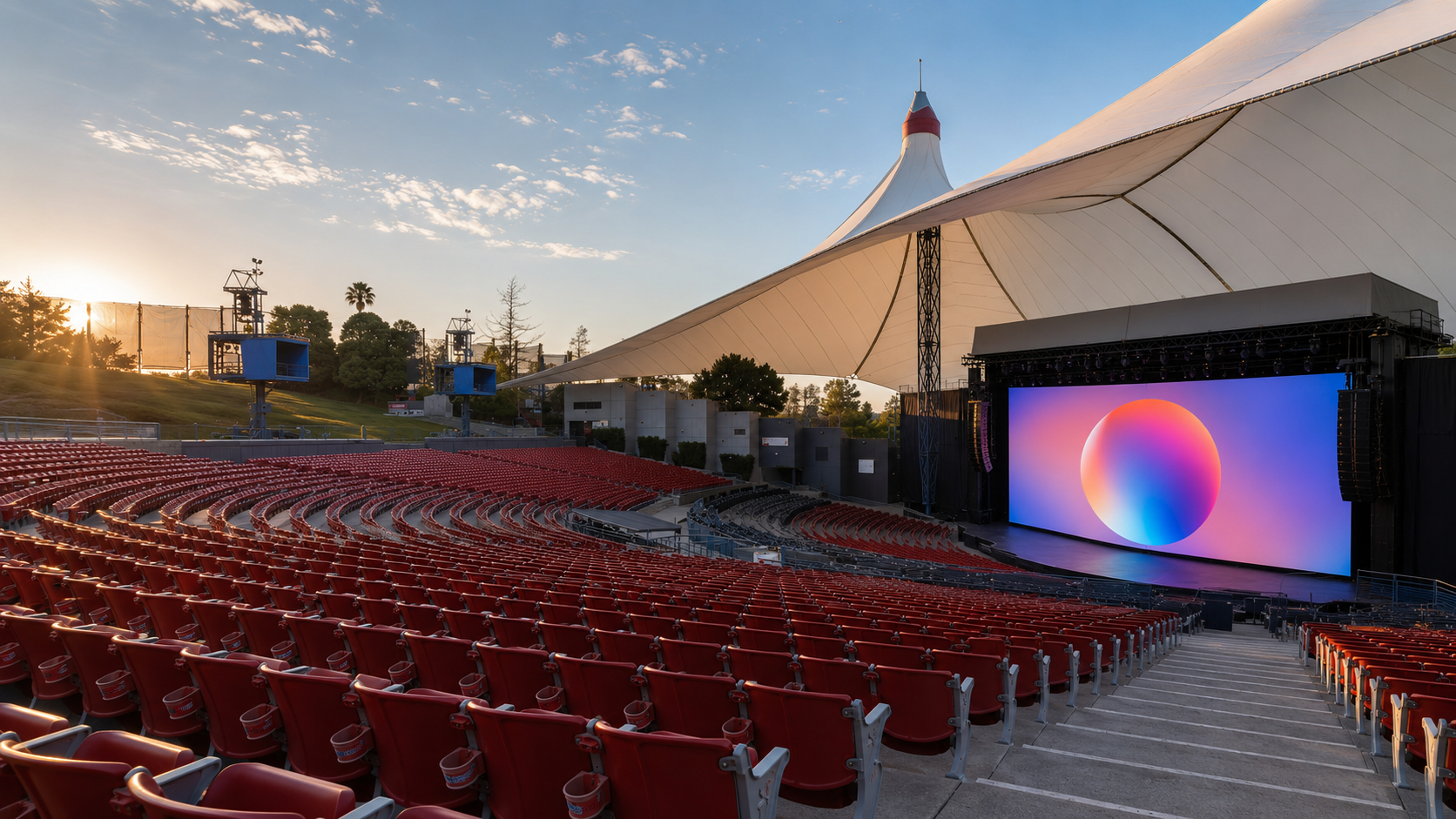 Sân khấu hội nghị Google I/O 2026 tại Shoreline Amphitheatre Mountain View sáng 19/05/2026 trước giờ keynote 10:00 PT: màn hình LED khổng lồ hiển thị logo Gemini gradient nhiều màu, kỳ vọng công bố Gemini 4.0 và kính Android XR đối tác Samsung cùng Warby Parker với giá mid-tier dưới 500 USD.